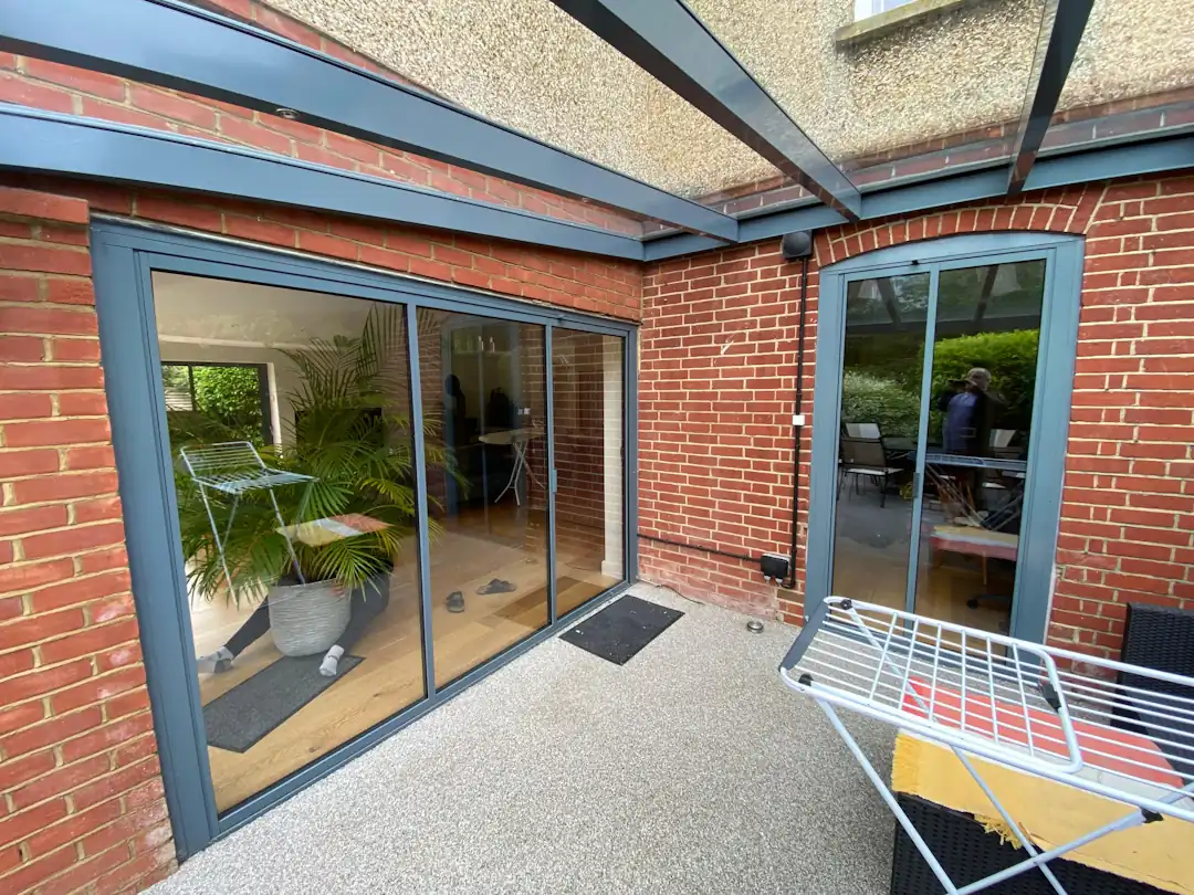 Anthracite grey bifold doors with matching back door in a modern brick home