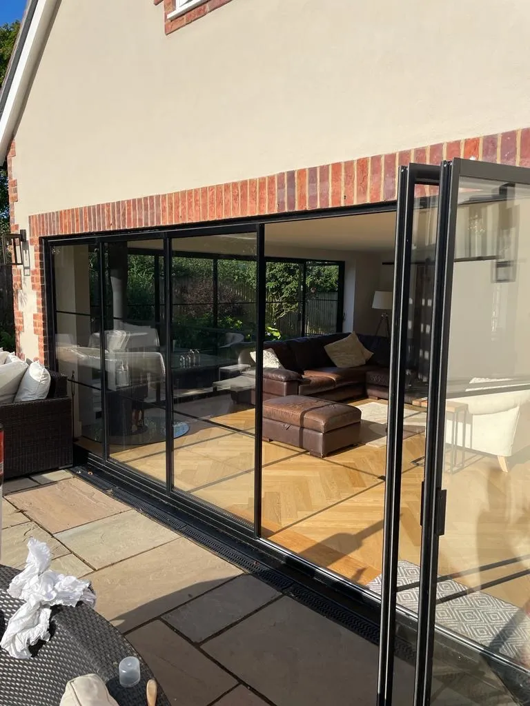 Black bifold doors with Georgian style integral bars