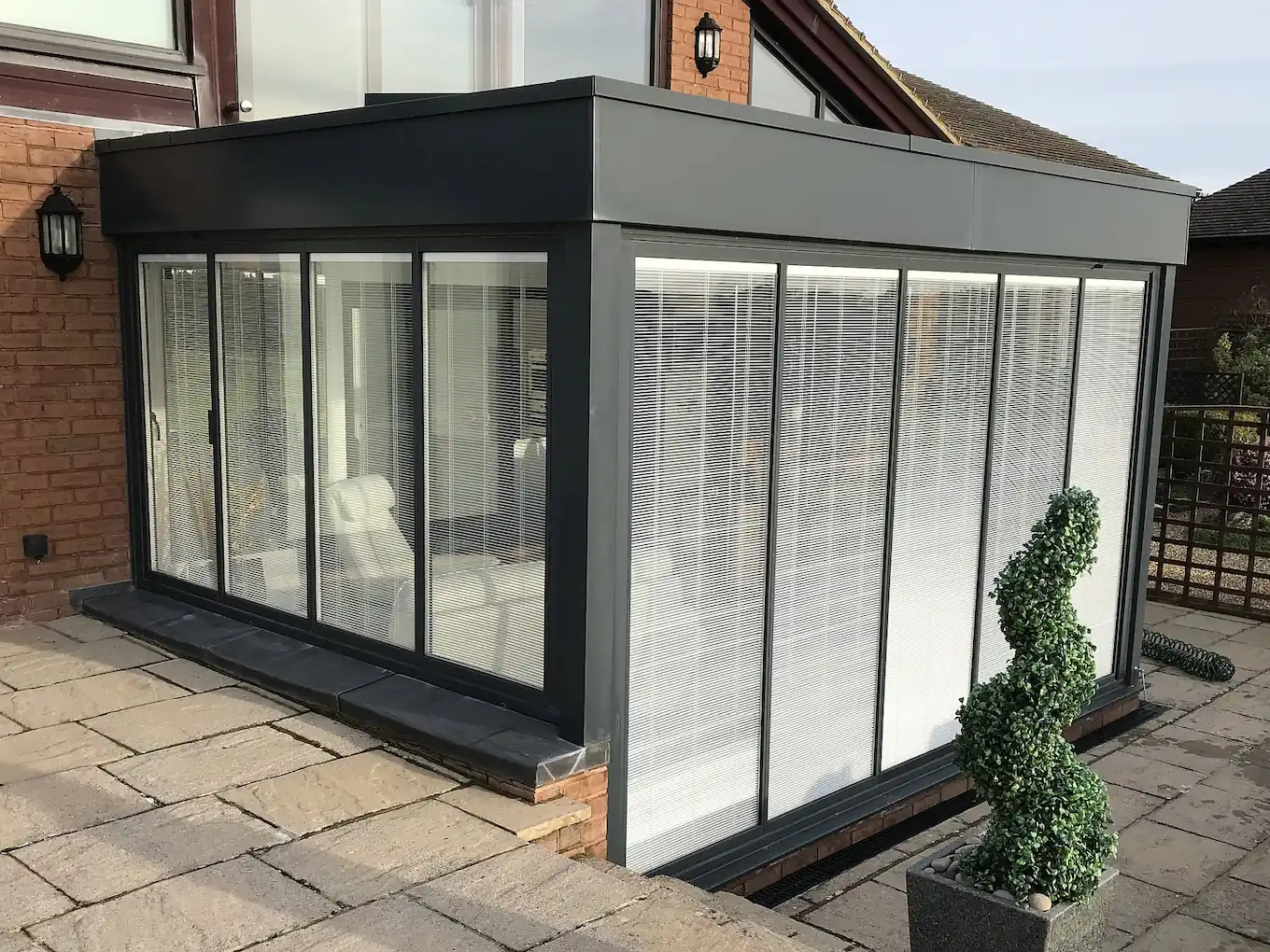 Bifold doors with integral blinds in a box extension