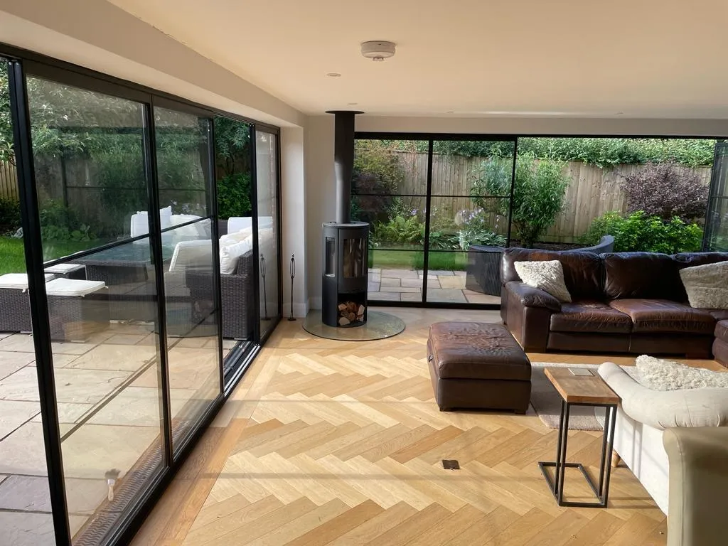 Living room with bifolds and a wood burning stove