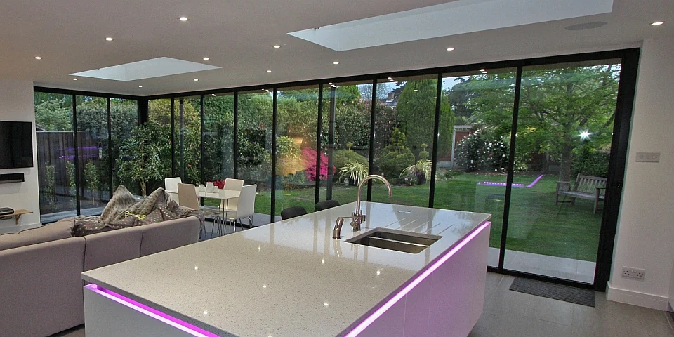 Ultra slim bifold doors kitchen area with pink LED strip mood lighting