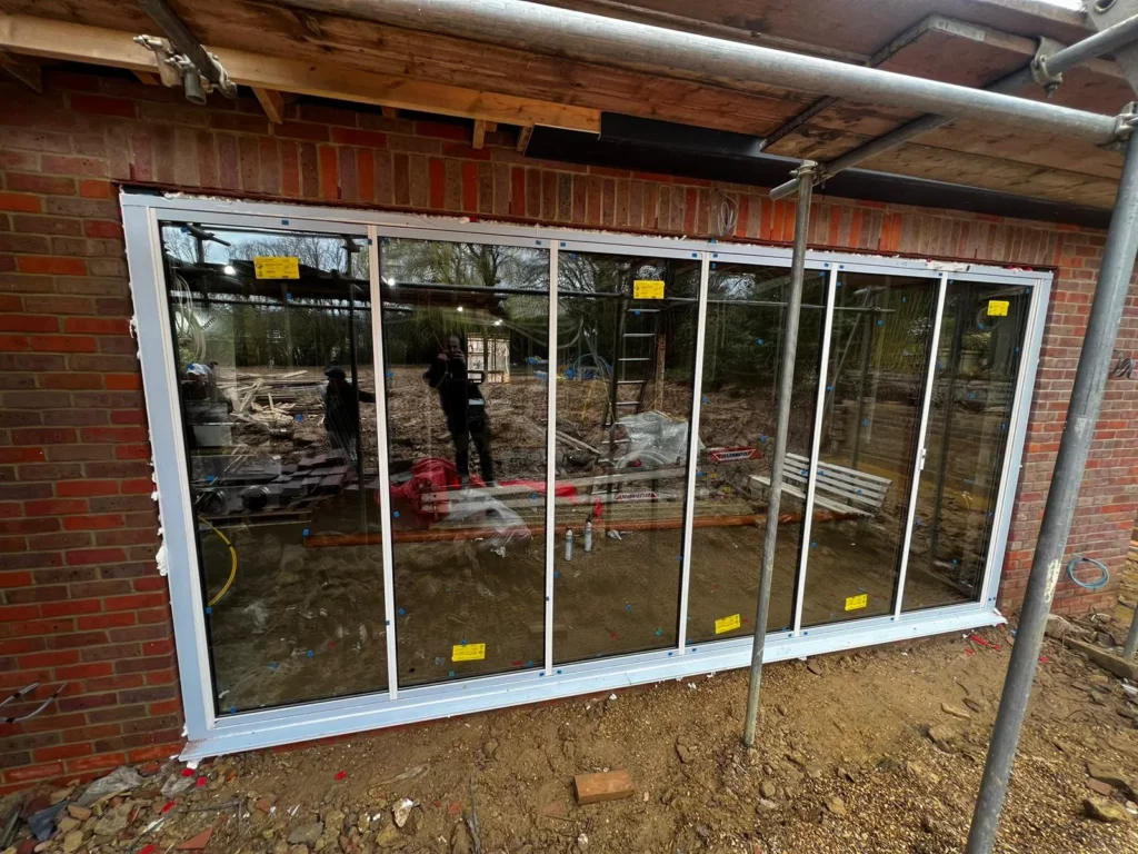 White bifold doors being installed