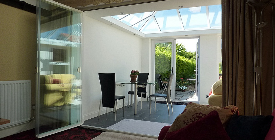 Conservatory with frameless internal bifold doors