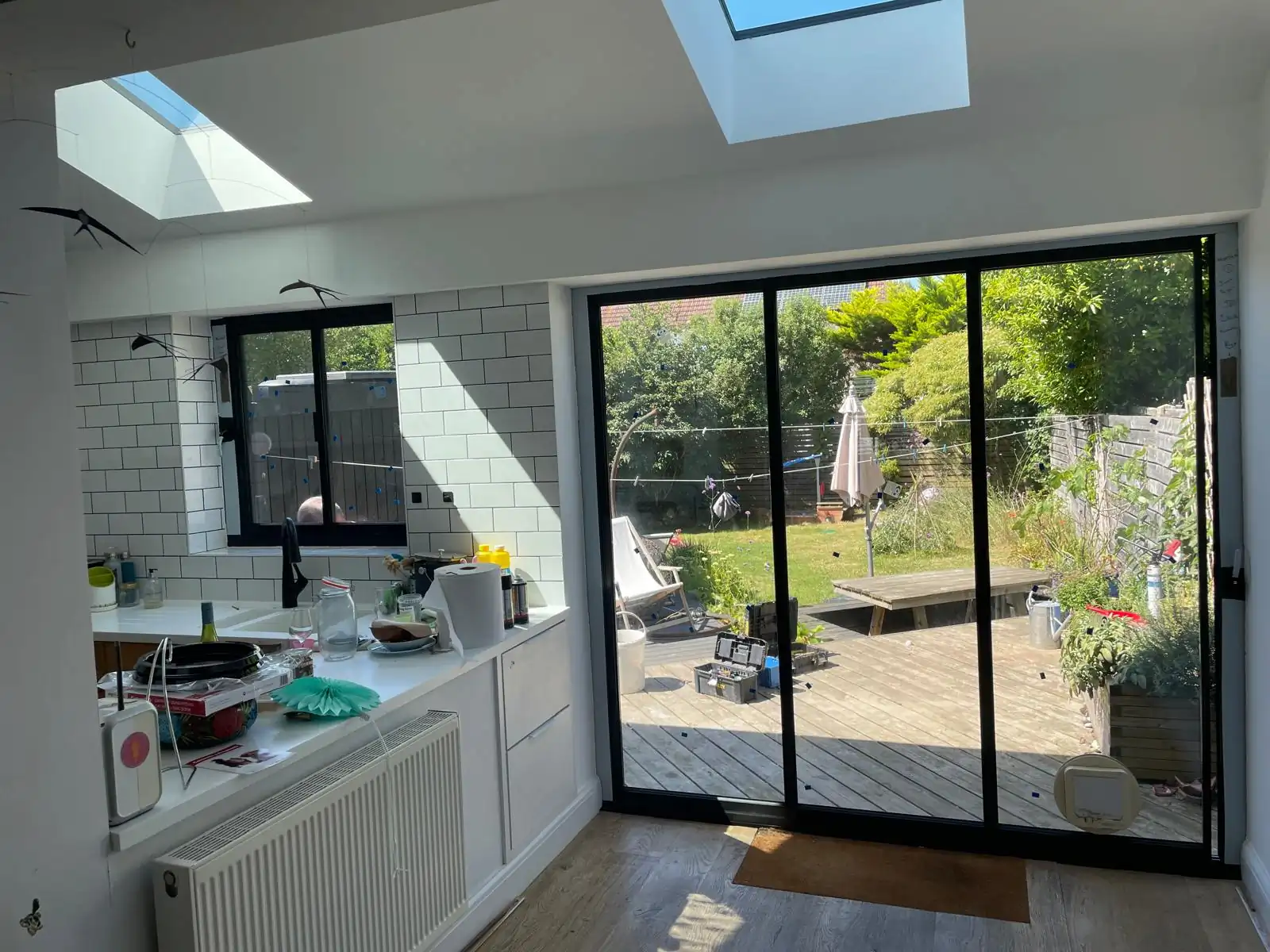 3 panel black sliding patio doors in a kitchen