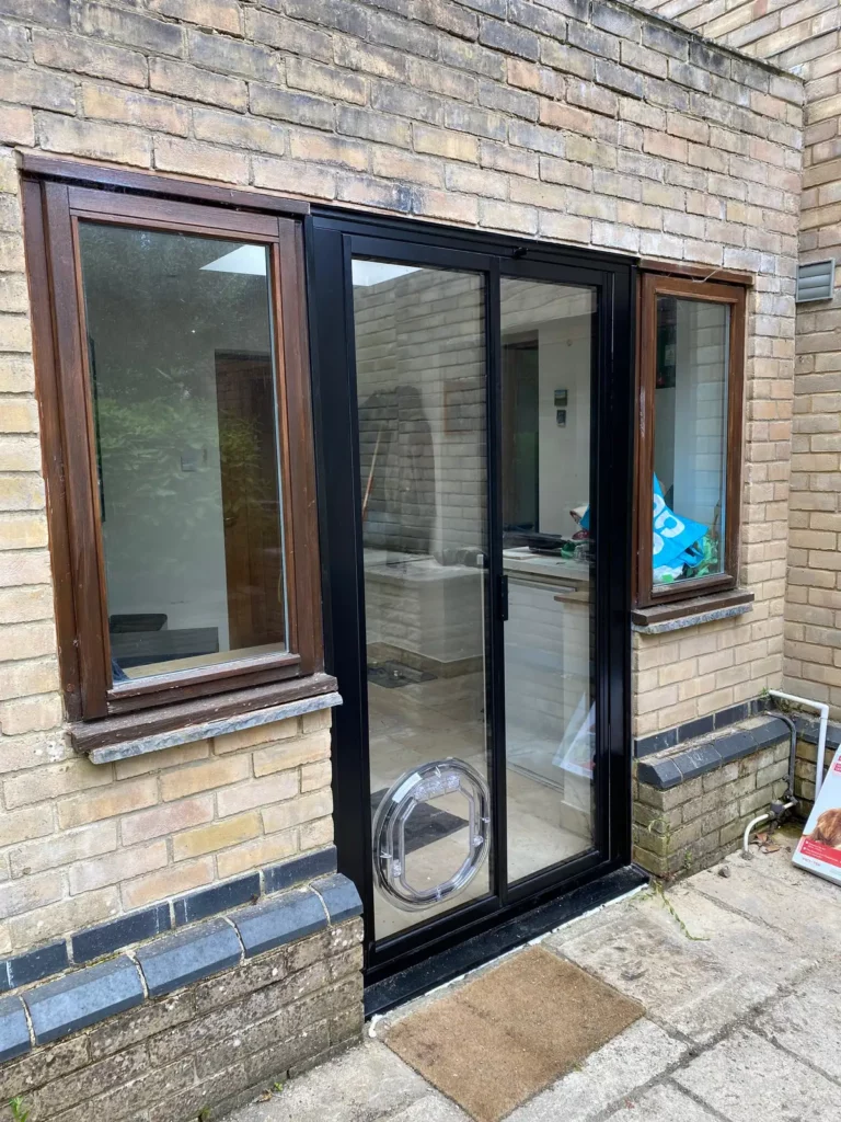 narrow exterior french doors with dog flap and side windows